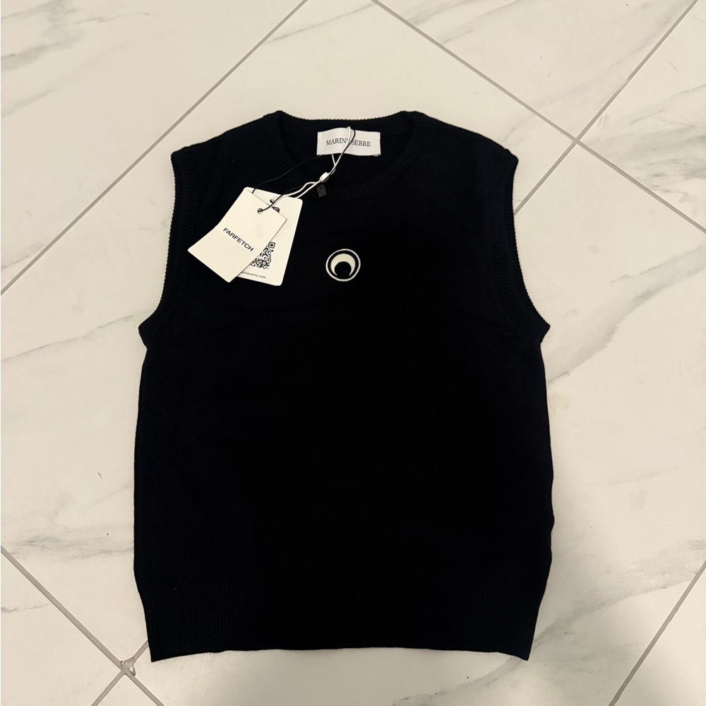Black Marine Serre sleeveless vest and jeans